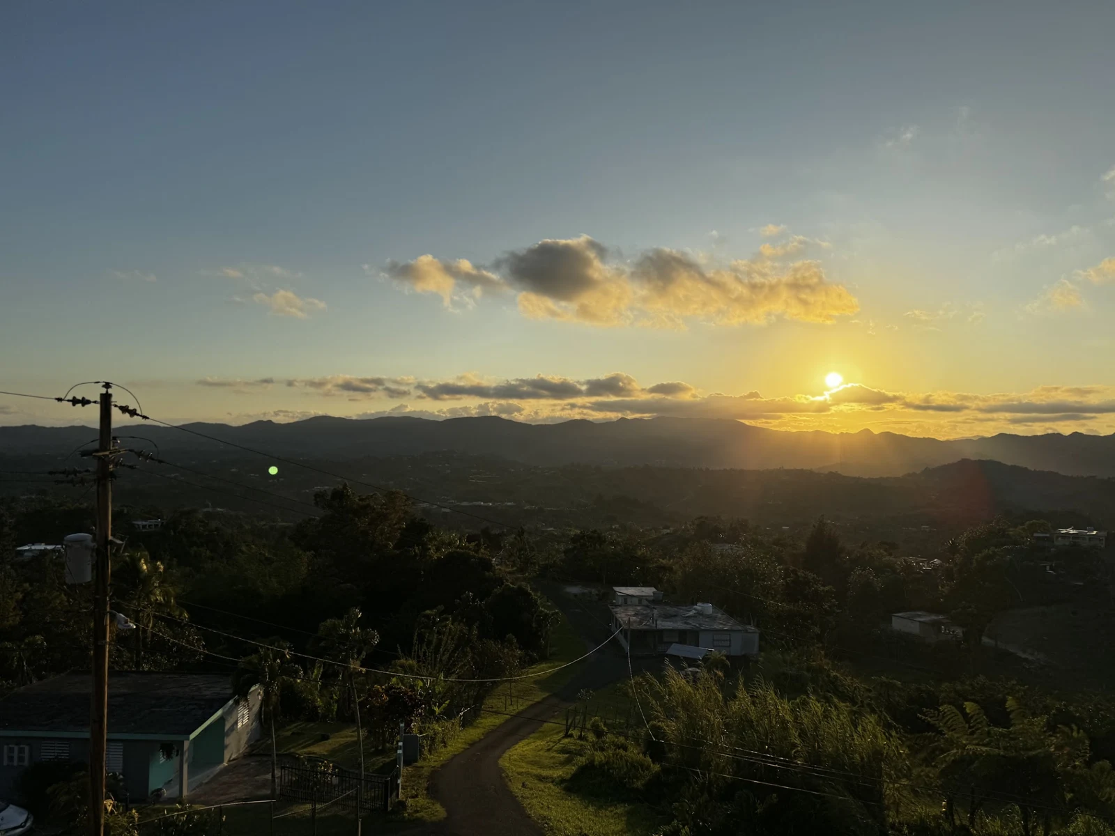 Amanecer sobre las montañas y casas de Puerto Rico